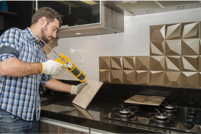 Kitchen Backsplash Installation by worker